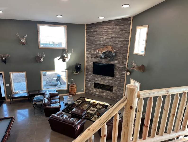 Stone fireplace great room at the Coteau View pheasant hunting lodge